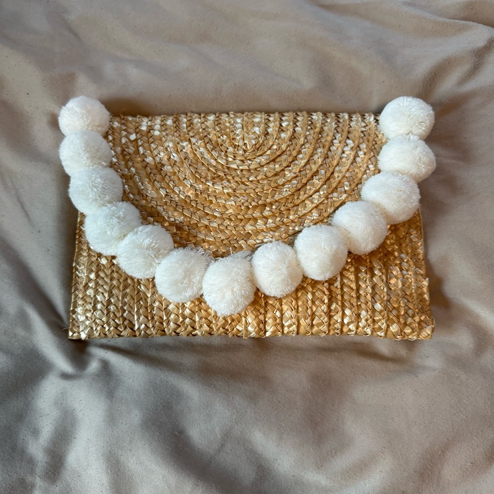 Shiraleah Gold Woven Clutch with White Pom-Poms